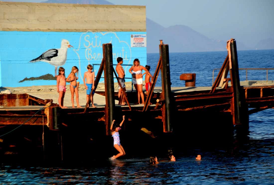 Il rito di iniziazione al mare dei bambini che si gettano dal porto (© Luca Bergamin)